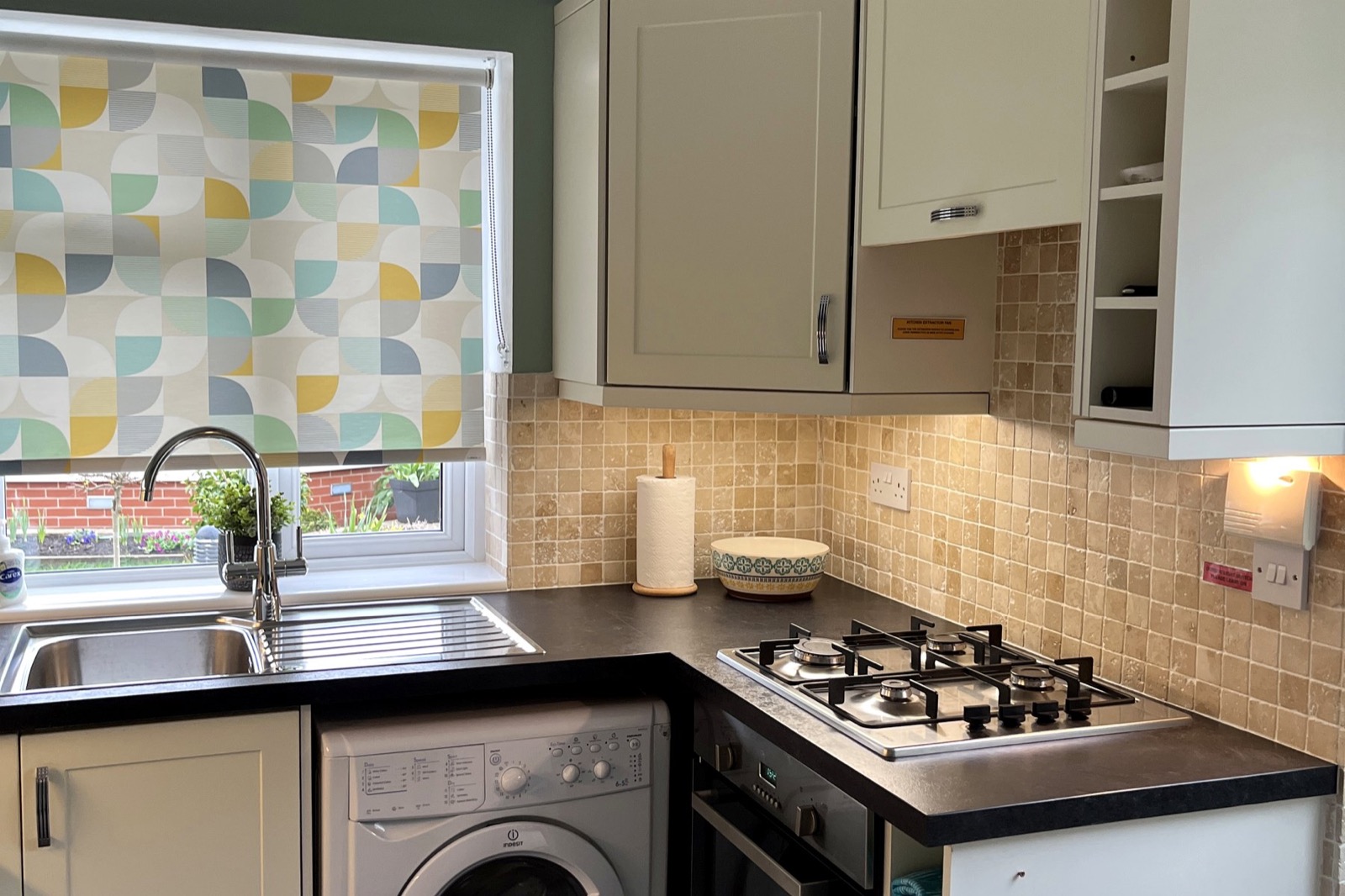 Fitted kitchen at The Bungalow Burnley with hob, oven, sink and washing machine